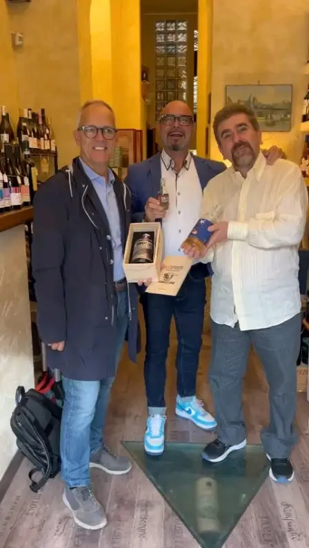 Il Professore e due ospiti con una confezione di distillati